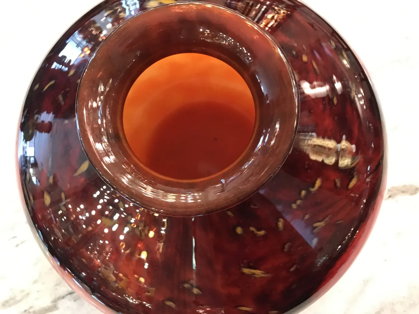 Top view of an antique signed glass by Schneider, featuring warm tones and subtle details.