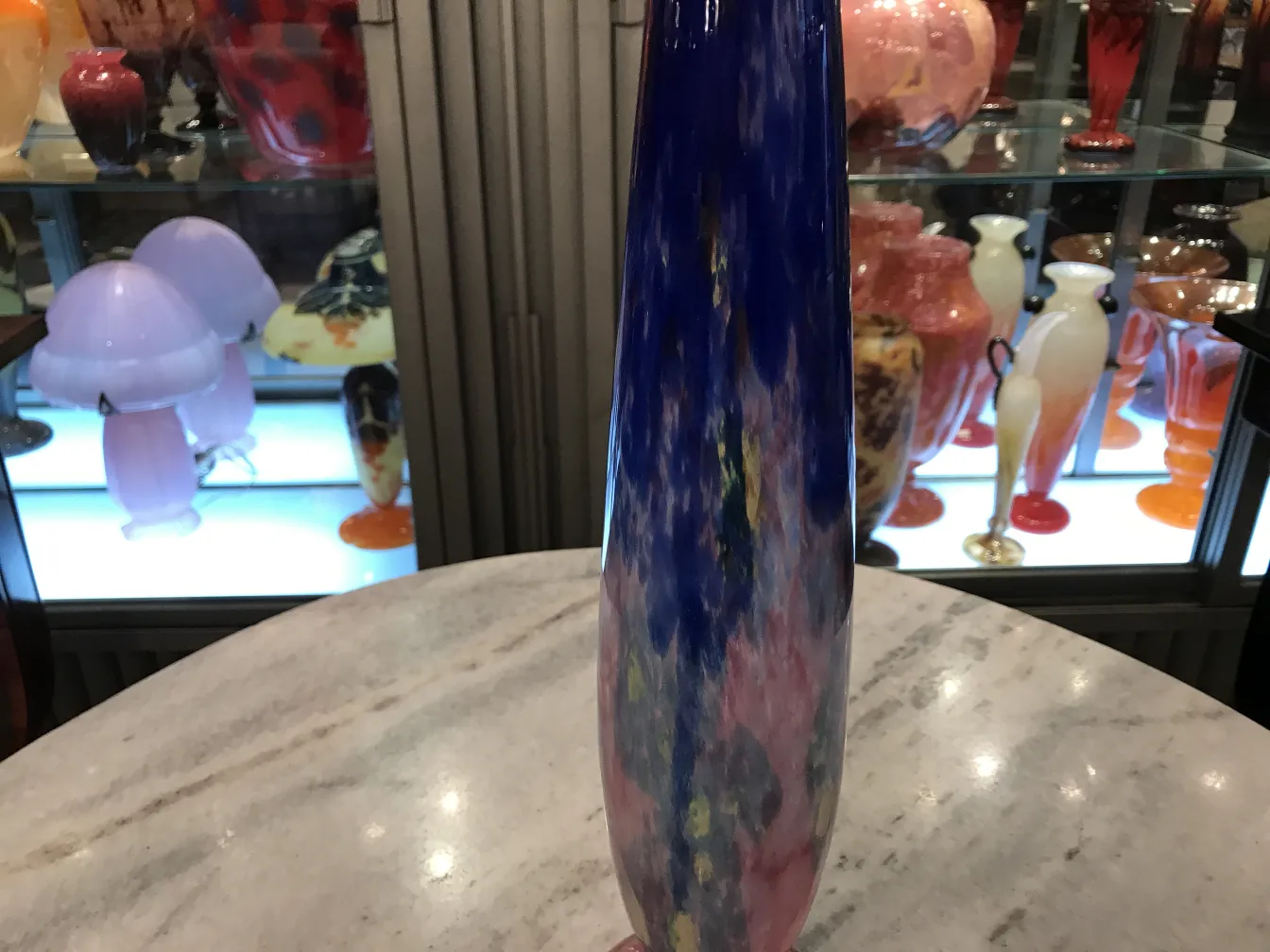 Vidrio firmado Schneider con colores vibrantes en un entorno de antigüedades