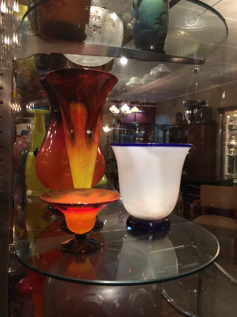 Verre antique signé Schneider avec des couleurs vives sur une étagère.