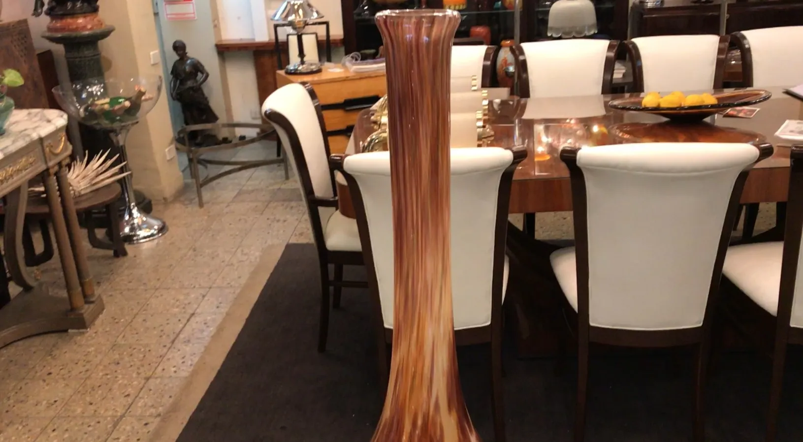 Tall vase in brown tones decorating an elegant space
