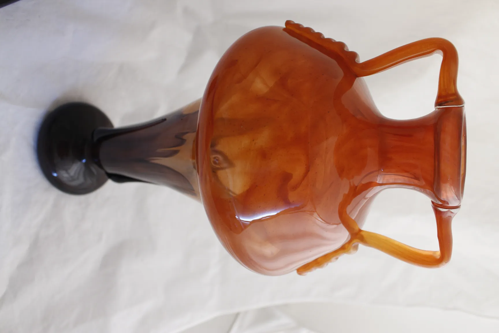 Antique glass vase with amber design and black base