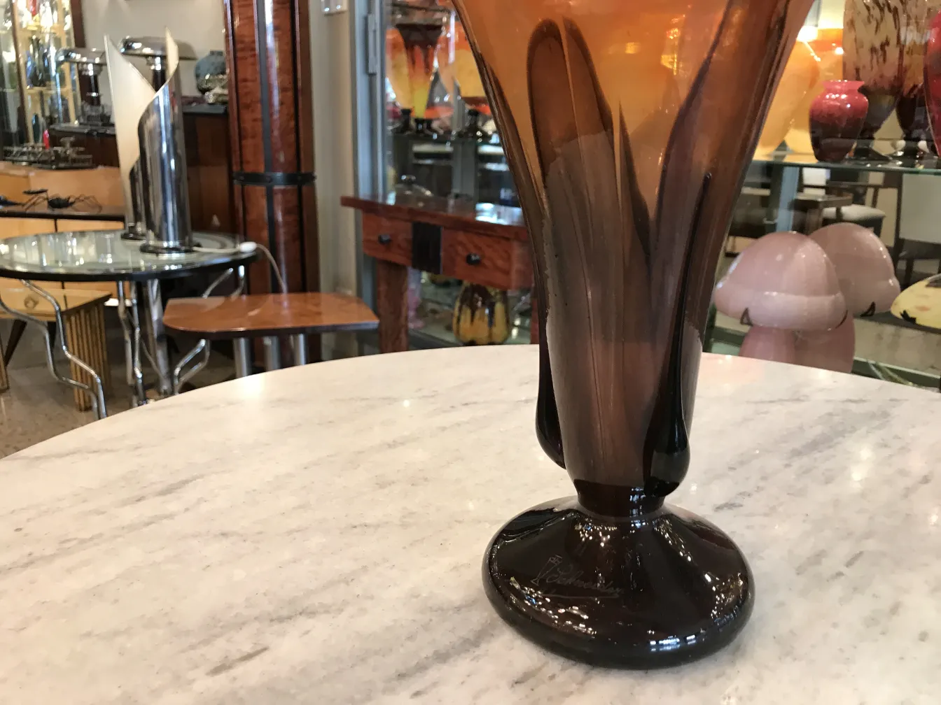 vidro assinado com base preta e decoração elegante ao fundo