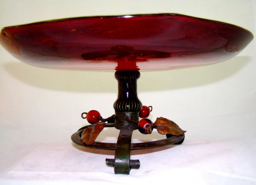 red glass plate with decorative base and colored details