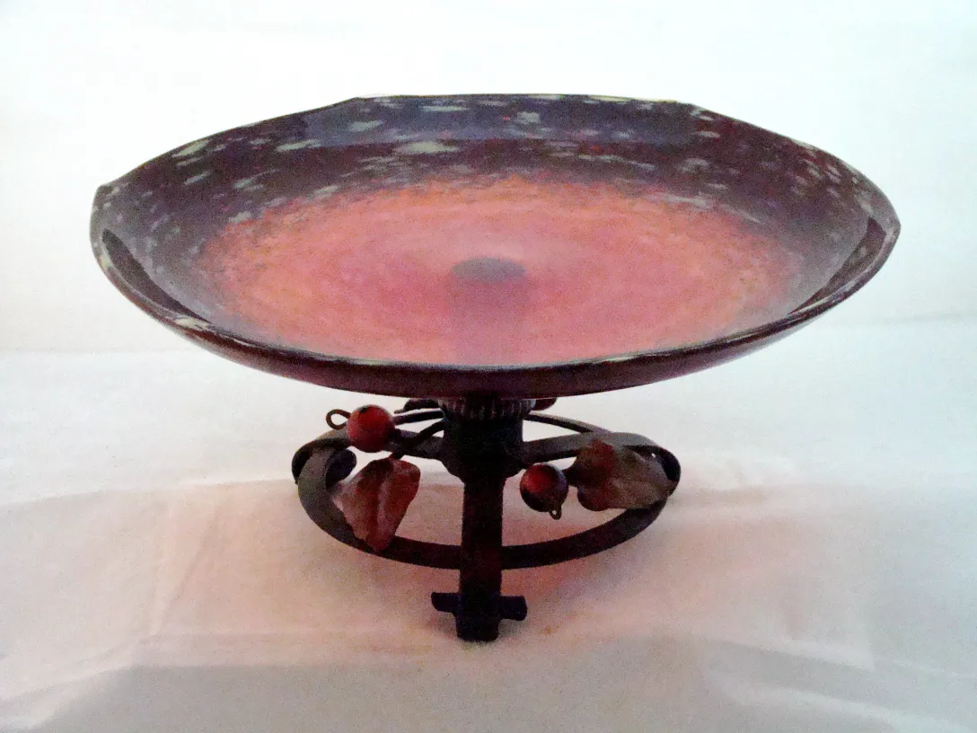 glass bowl with decorative base and red hues