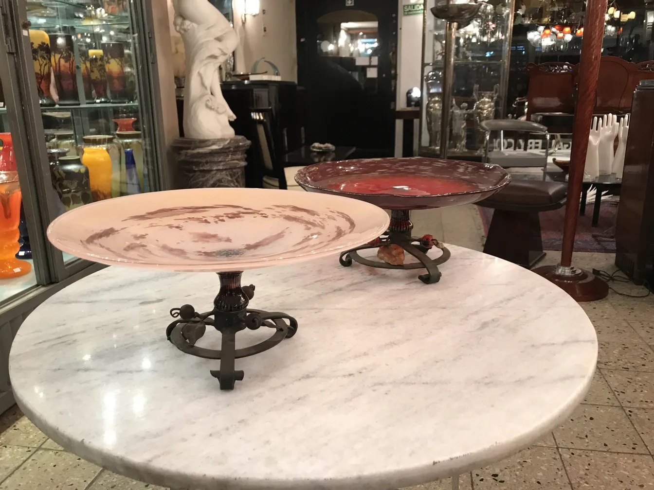 two decorative glass plates in an antique setting