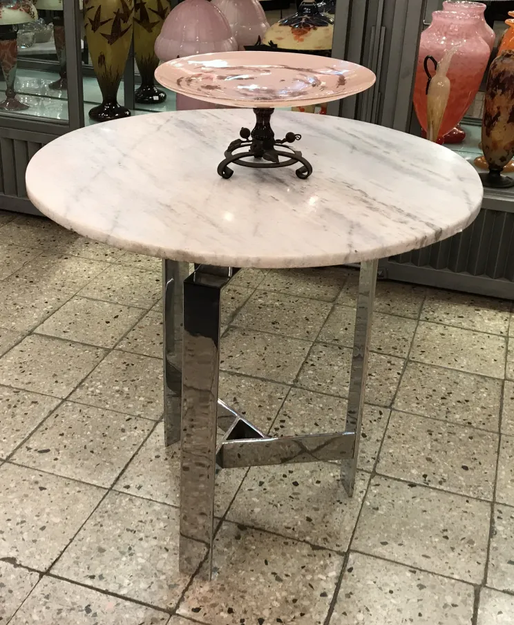Round antique glass table with black pedestal and pink tray