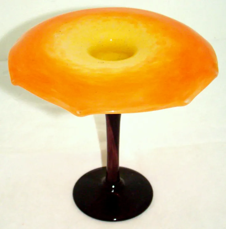 Signed glass with orange and yellow tones on a base