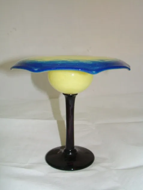 Signed glass with blue and yellow colors and dark base