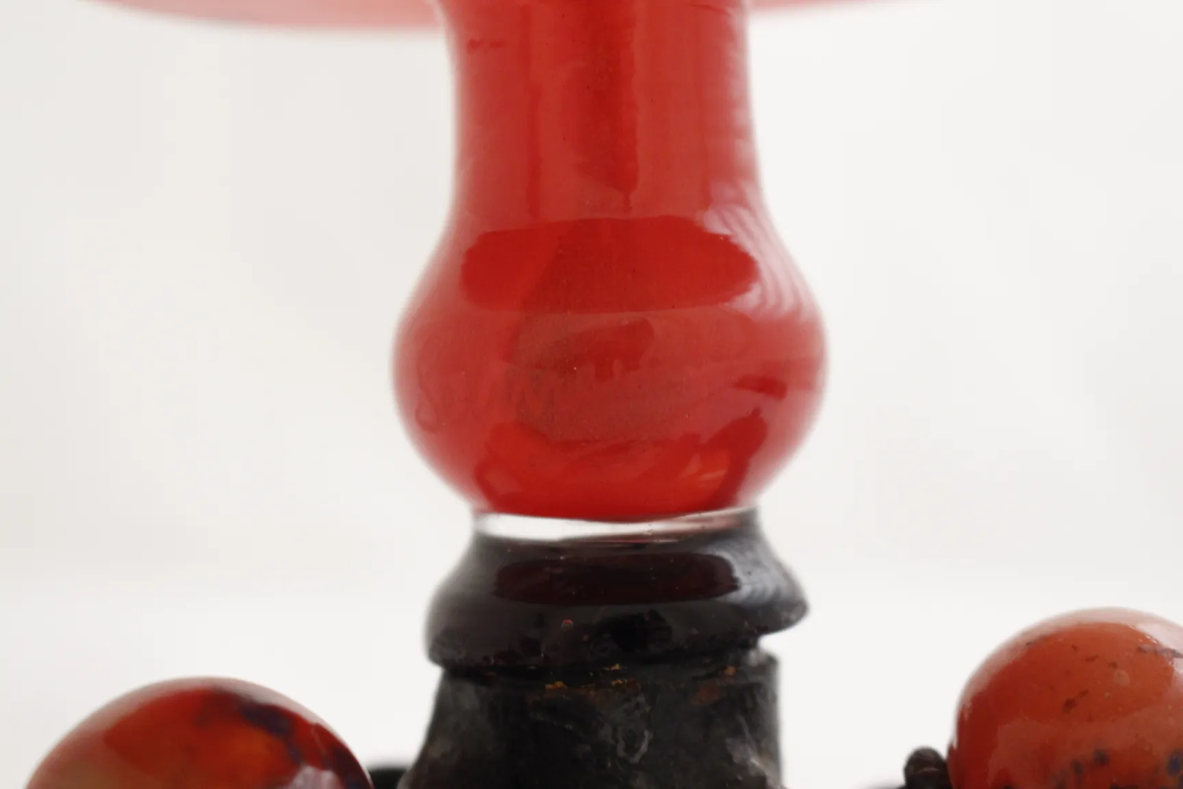 signed glass with artistic details in red hue