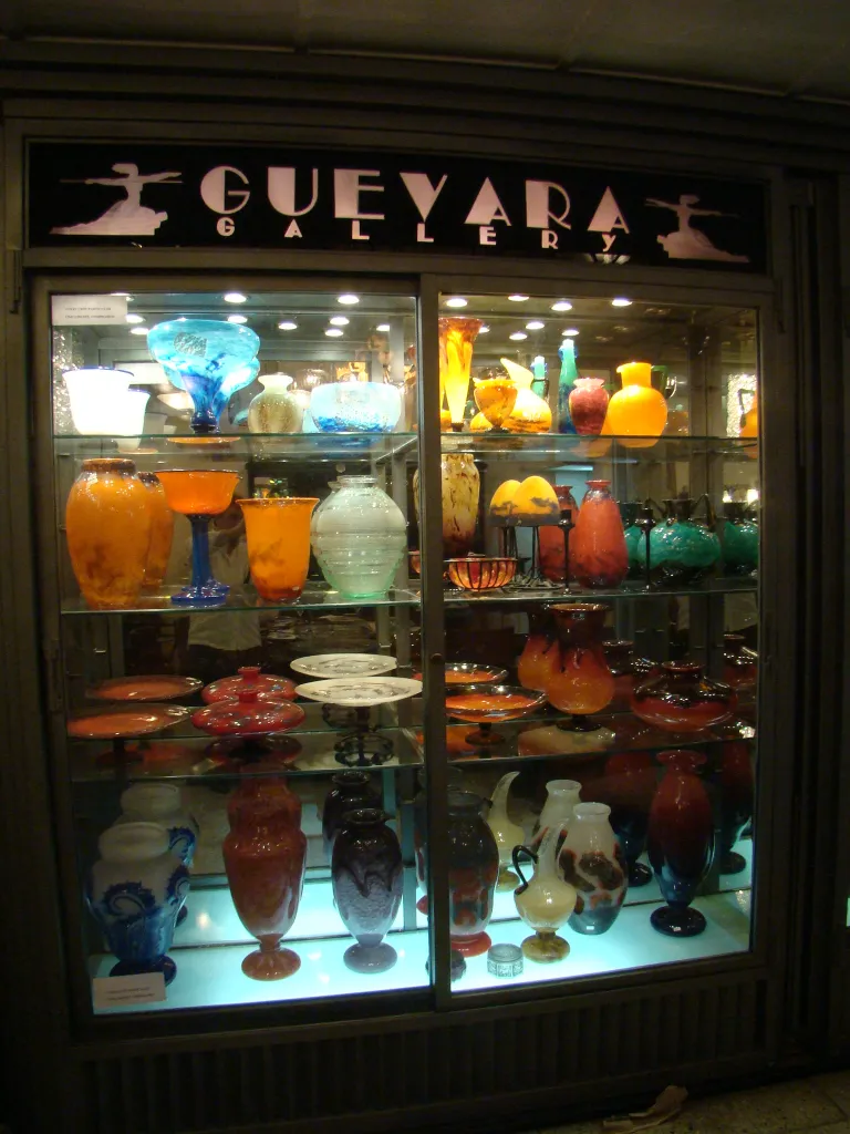 signed glass schneider displayed with other items