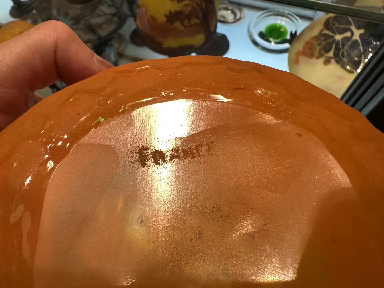 Signed glass by Schneider featuring antique details and decorative surroundings.