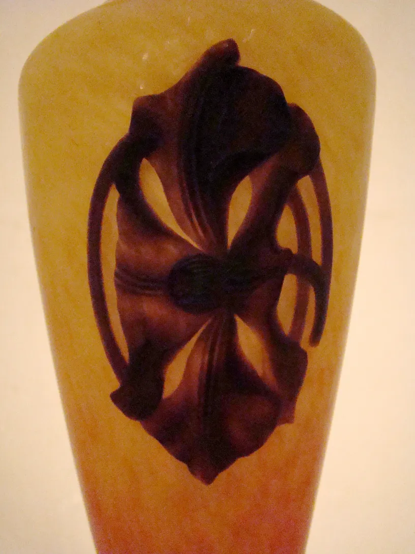 Antique glass with dark relief design on the front, floral style