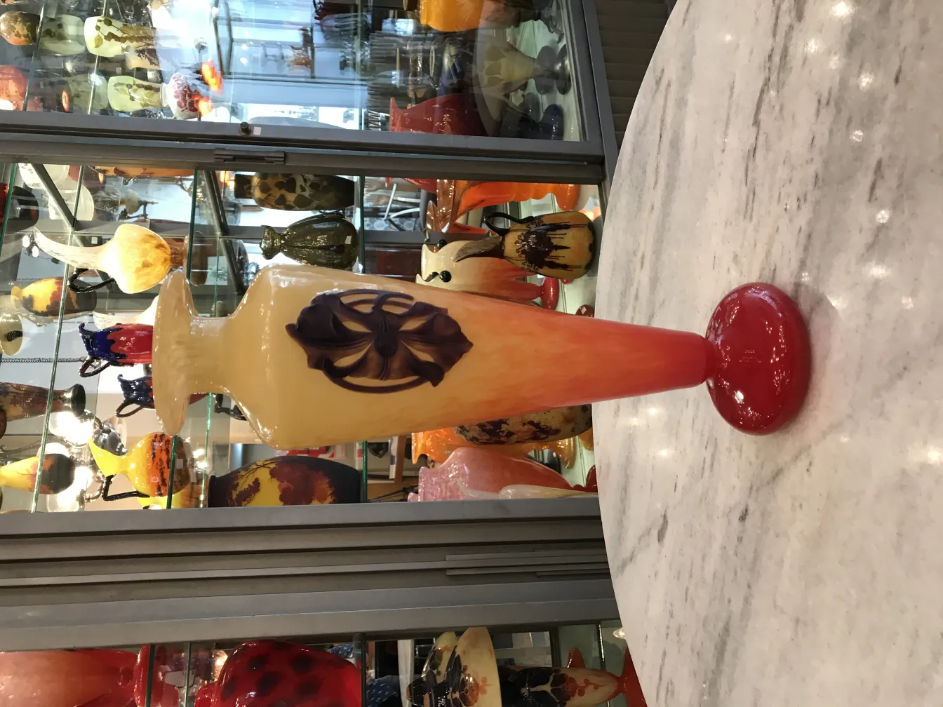 Antique signed glass by Schneider with red base and decorative design.