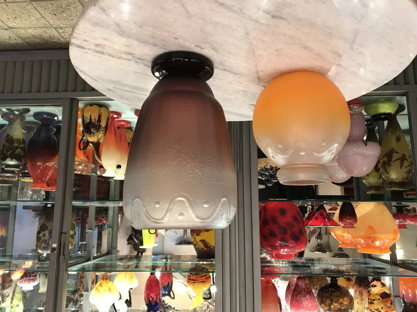 Glass signed by Schneider, amid other antique pieces