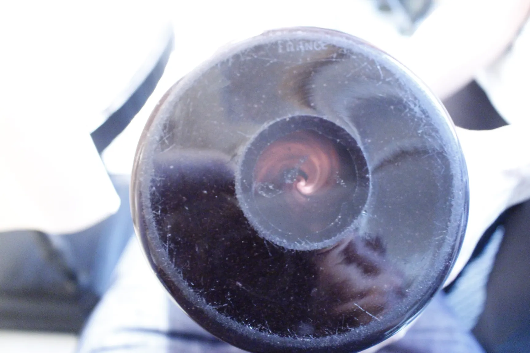 View of the bottom of the antique signed glass Schneider, featuring unique visual details.