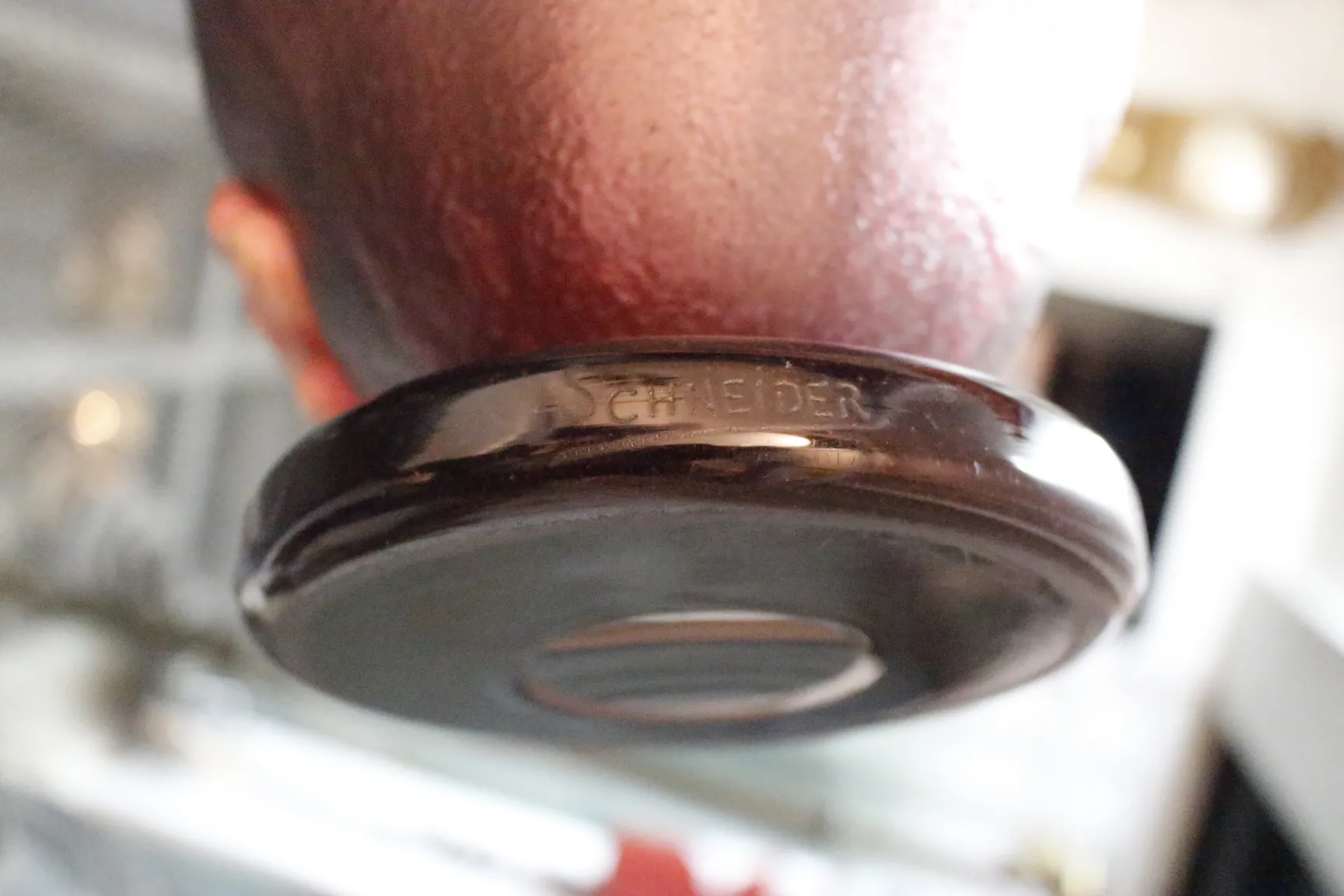 Close-up of the base showing 'Schneider' mark, decorative antique.