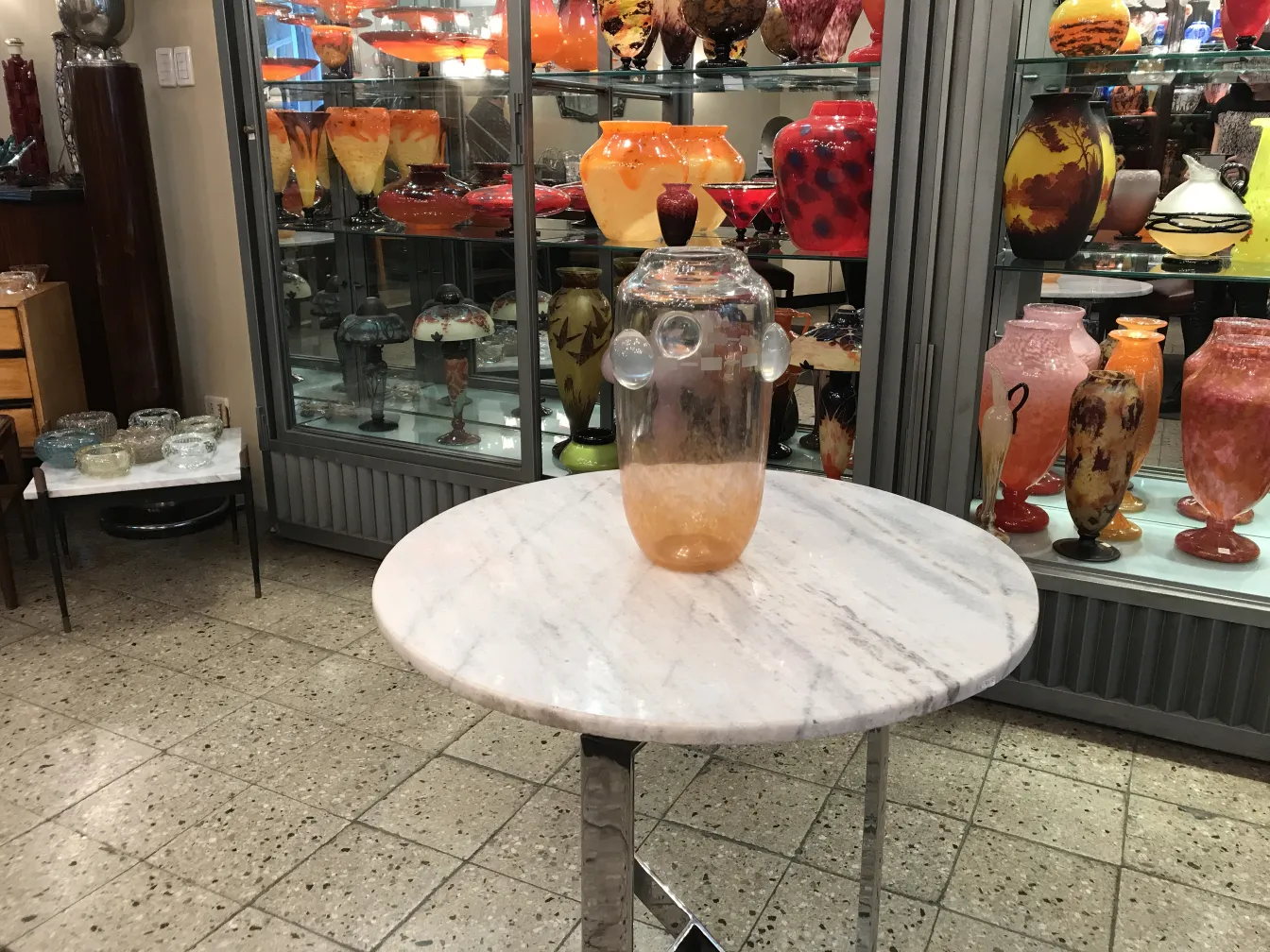 glass signed by Schneider on table with colorful background
