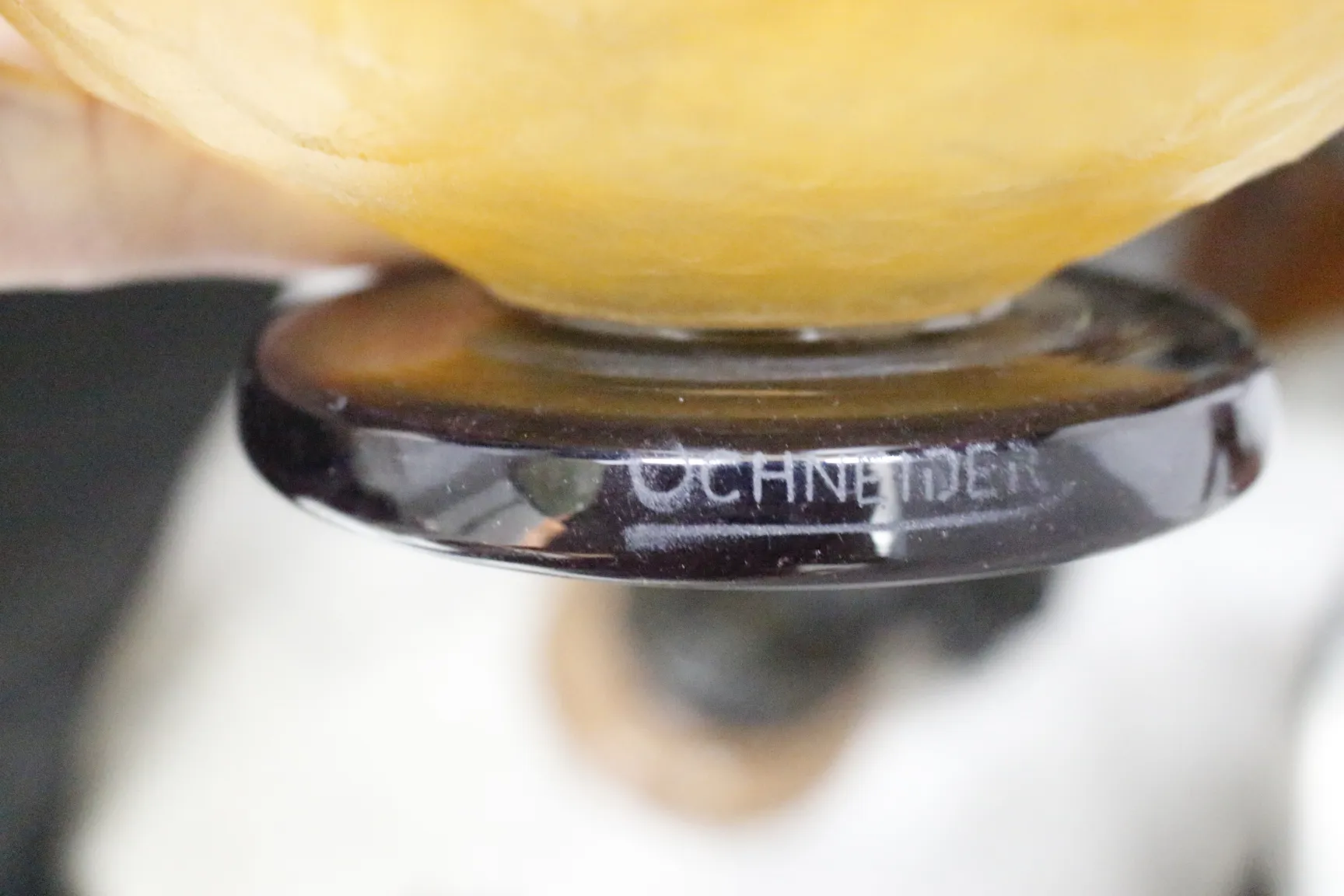 Antique signed Schneider glass in a dim setting.