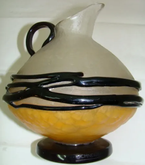antique glass jug with black and orange details, signed Schneider