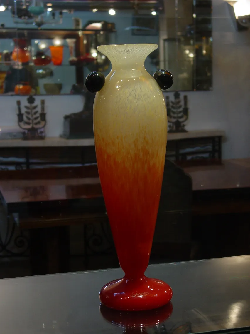 Antique glass piece with a beautiful red and yellow gradient design and dark details.