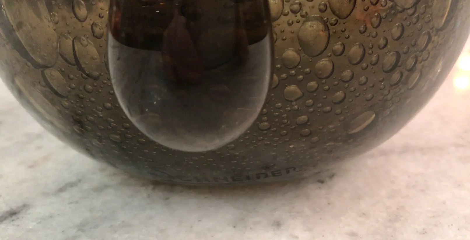 signed glass by schneider featuring water droplets on surface