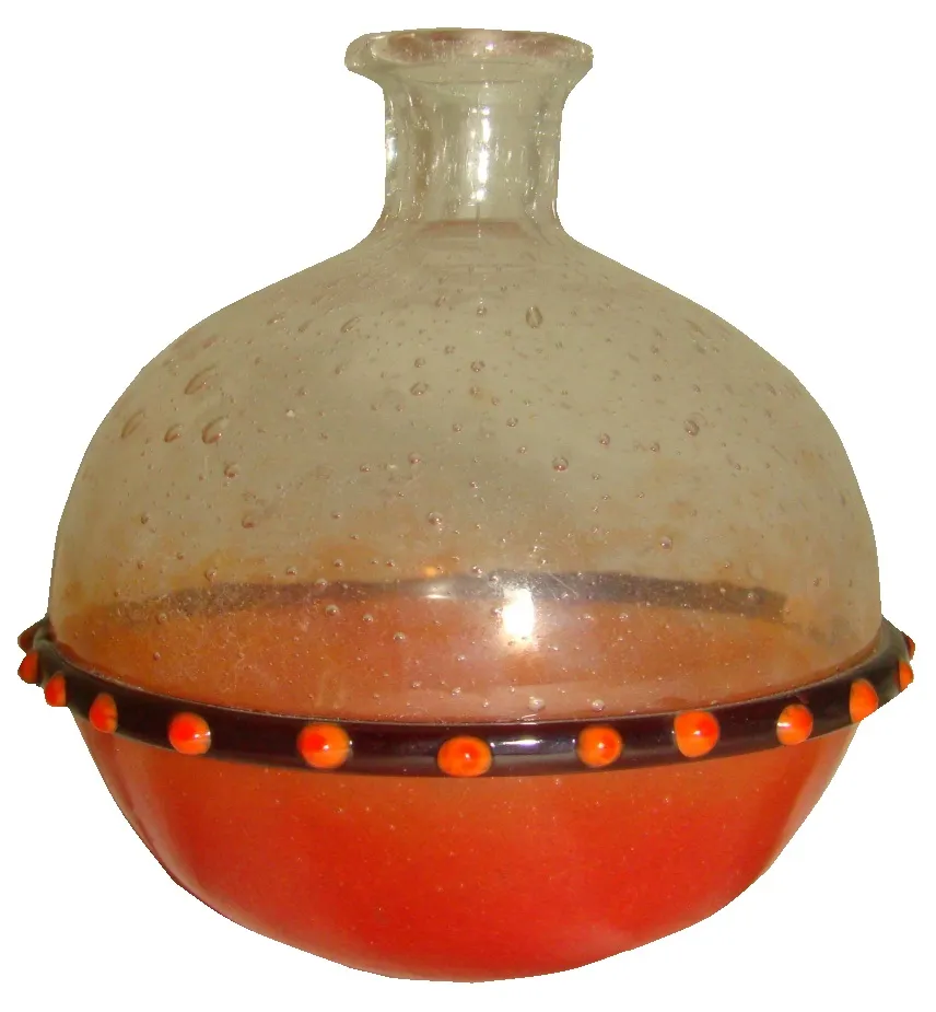 Antique glass with round base and decorative elements.