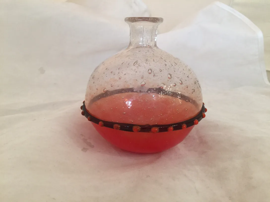 Antique signed glass Schneider with round shape and red base.