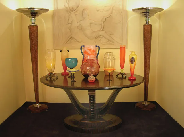 Antiques displayed on a table with signed glass pieces