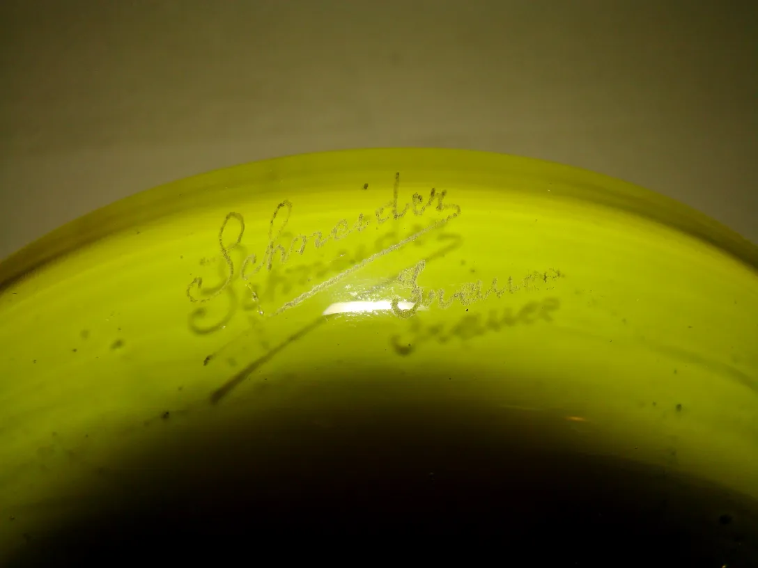 Antique signed glass by Schneider with visible details. The item features a rounded shape and distinctive color.