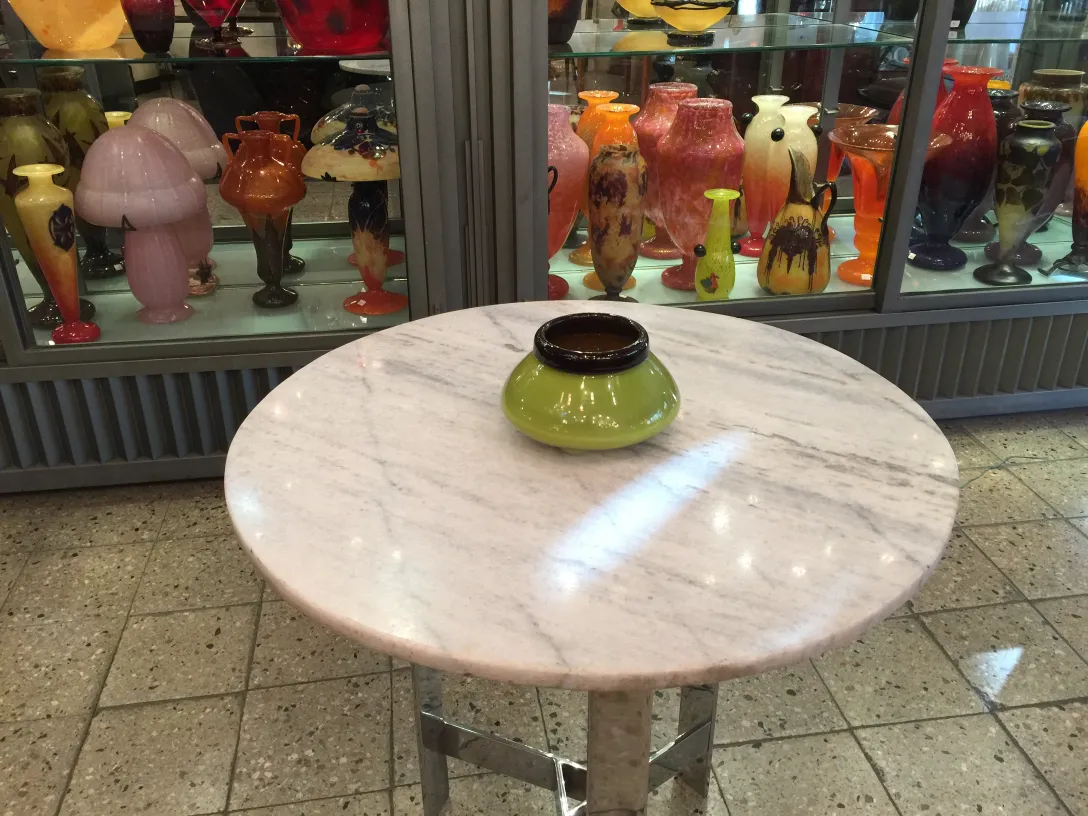 Signiertes Glas Schneider auf einem Tisch in antikem Ambiente.