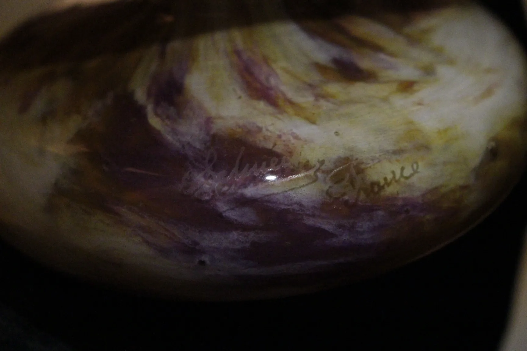 Antique signed glass Schneider with purple and yellow patterns.