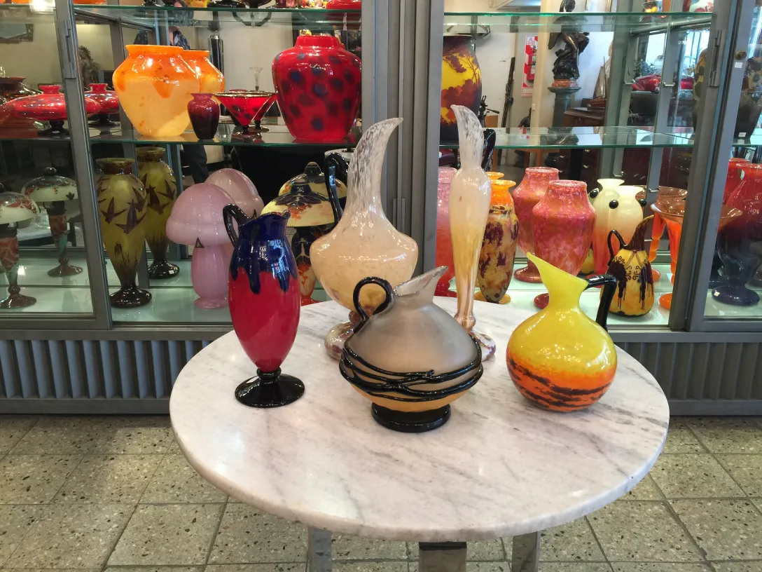 Collection of antiques featuring signed Schneider glass in vibrant colors