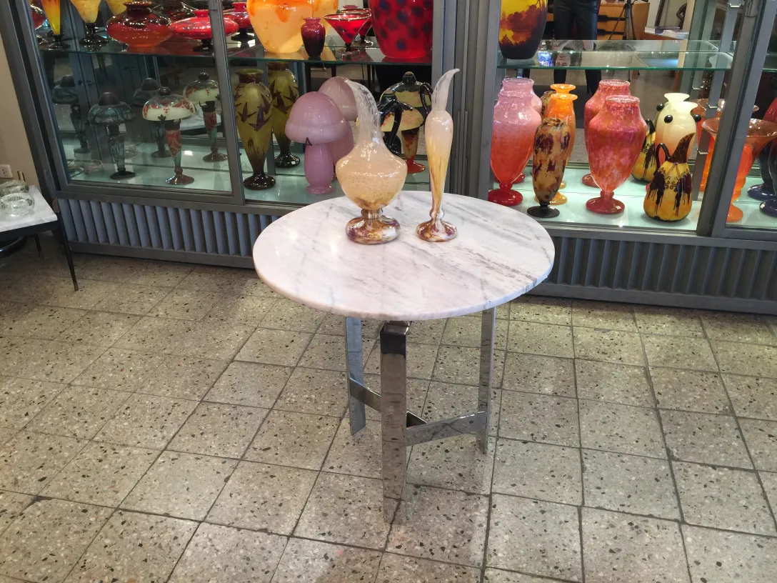 signed glass by schneider displayed among antiques