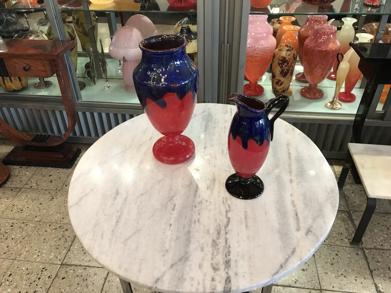 antique pitcher with blue and red colors, vintage setting