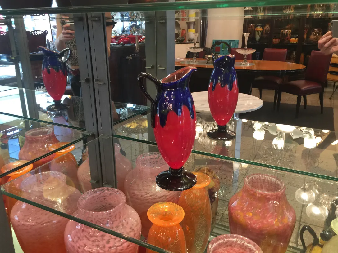 SIGNED GLASS Schneider displayed among vintage items.