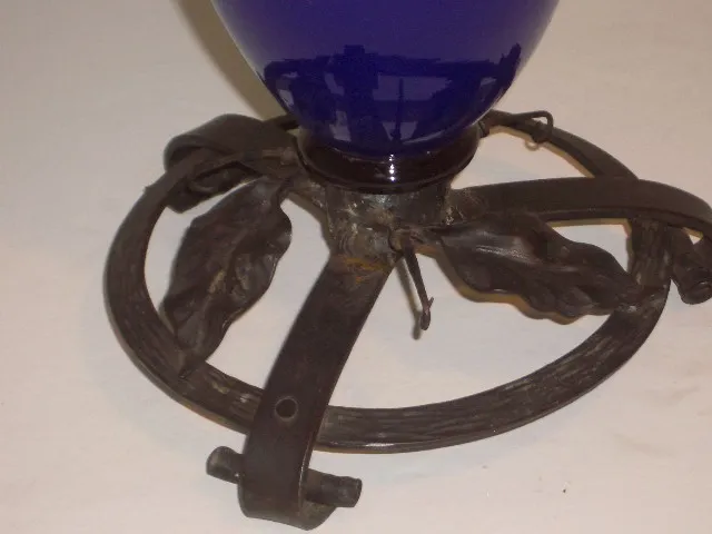 Antique piece with decorative base and blue signed glass.