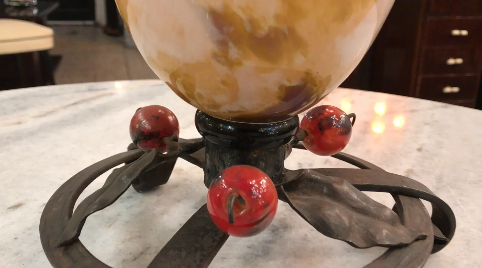 Signed glass by Schneider featuring decorative details.