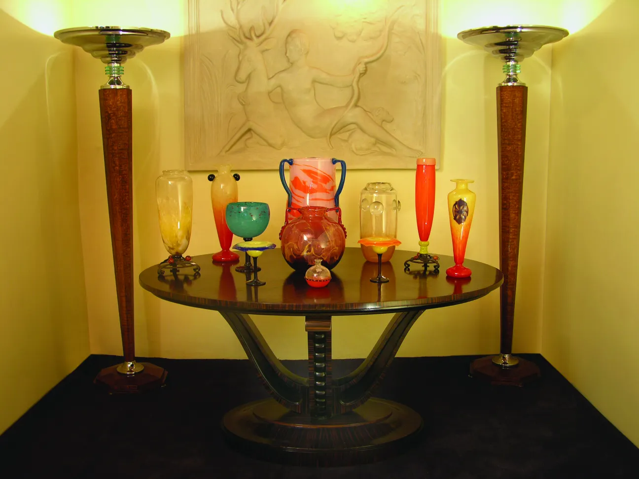 Signed glass Schneider on decorative table with antiques.