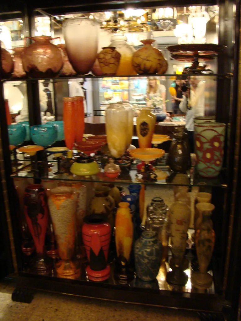 signed glass on shelf with other decorative items