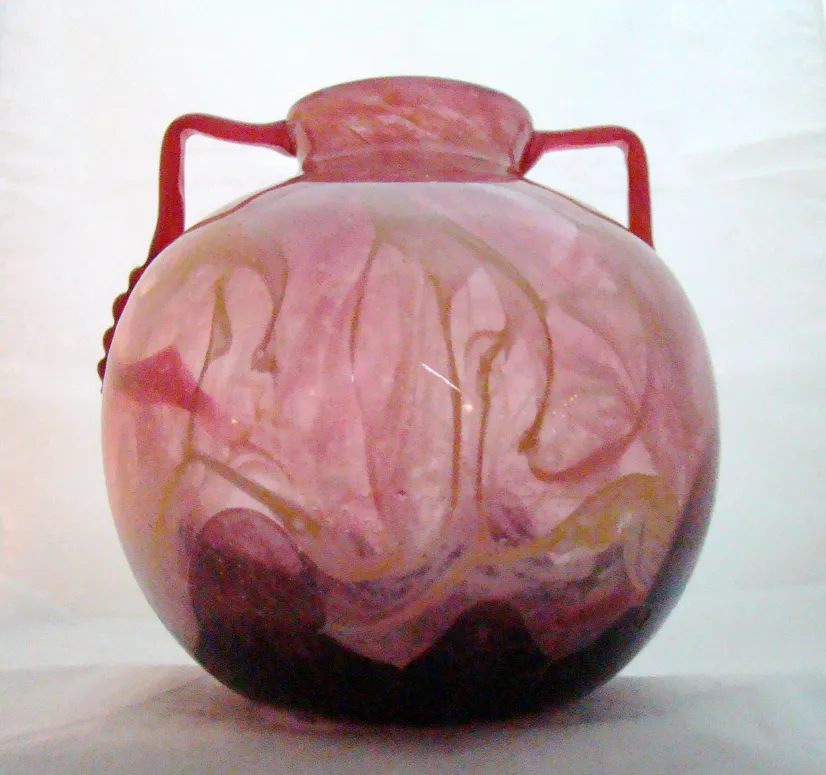 Glass with Schneider's signature in a pink and gold shade.