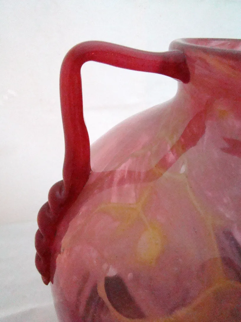 SIGNED GLASS Schneider featuring a colorful design and a unique handle.