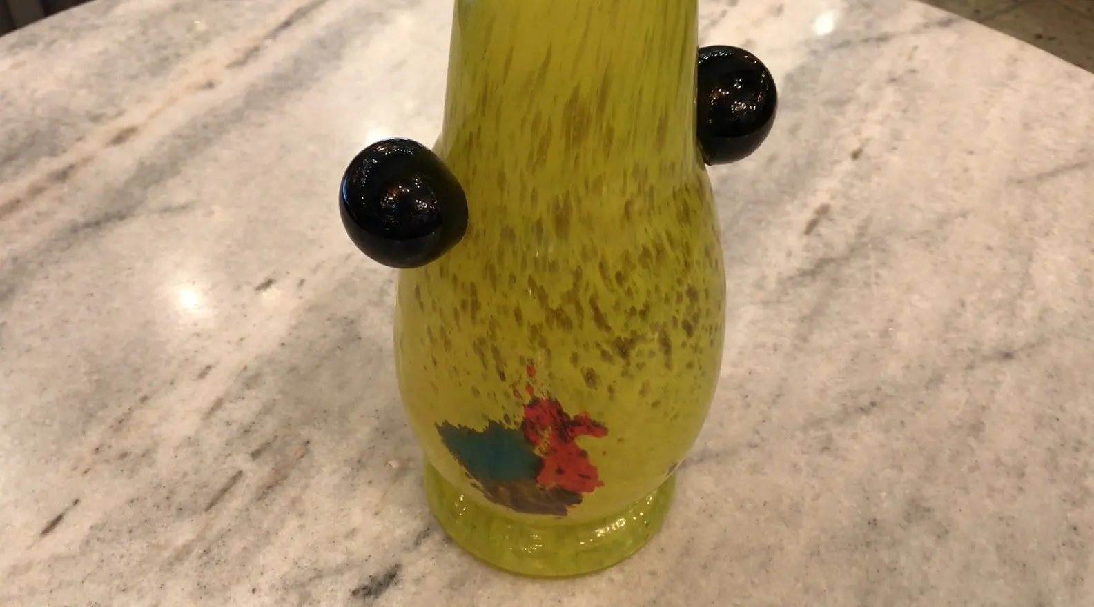 Antique yellow glass with signature details in an elegant setting.