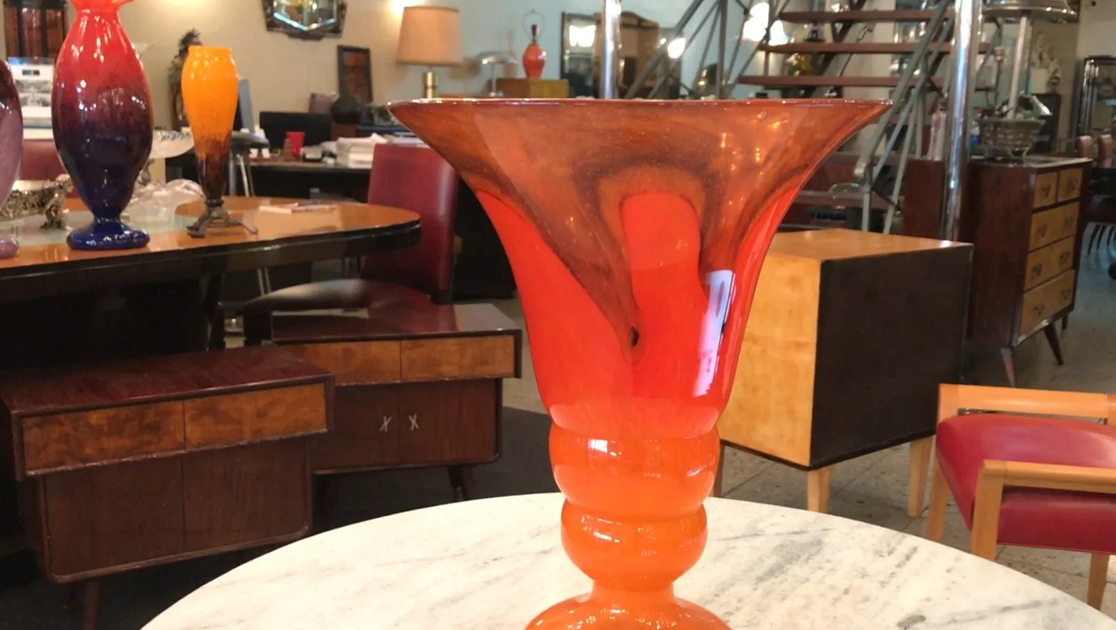 vaso antico in vetro firmato, colore arancione brillante, ambiente accogliente