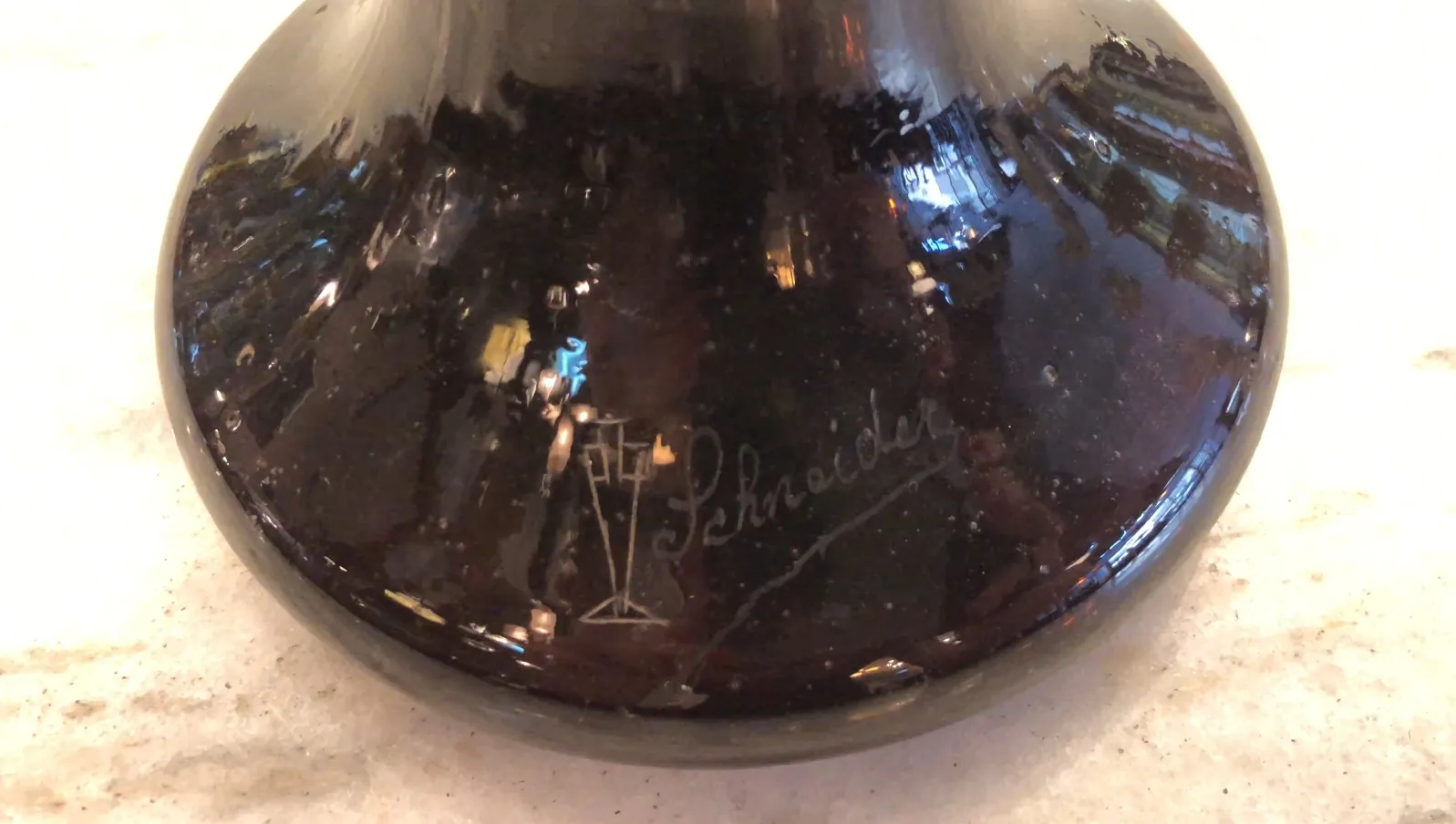 signed glass with visible signature of Schneider, neutral background
