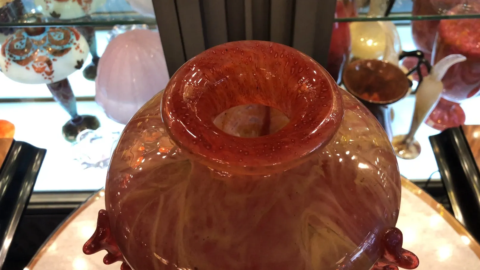 Antique signed glass Schneider in red, decorative background.