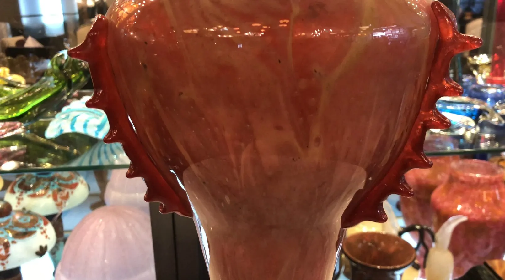 antique glass signed by Schneider featuring decorative details in warm tones