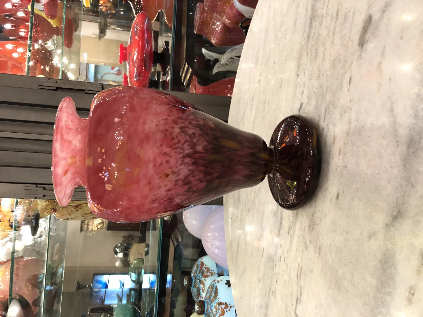 Elegant vase in shades of pink and purple with a base, antique style.