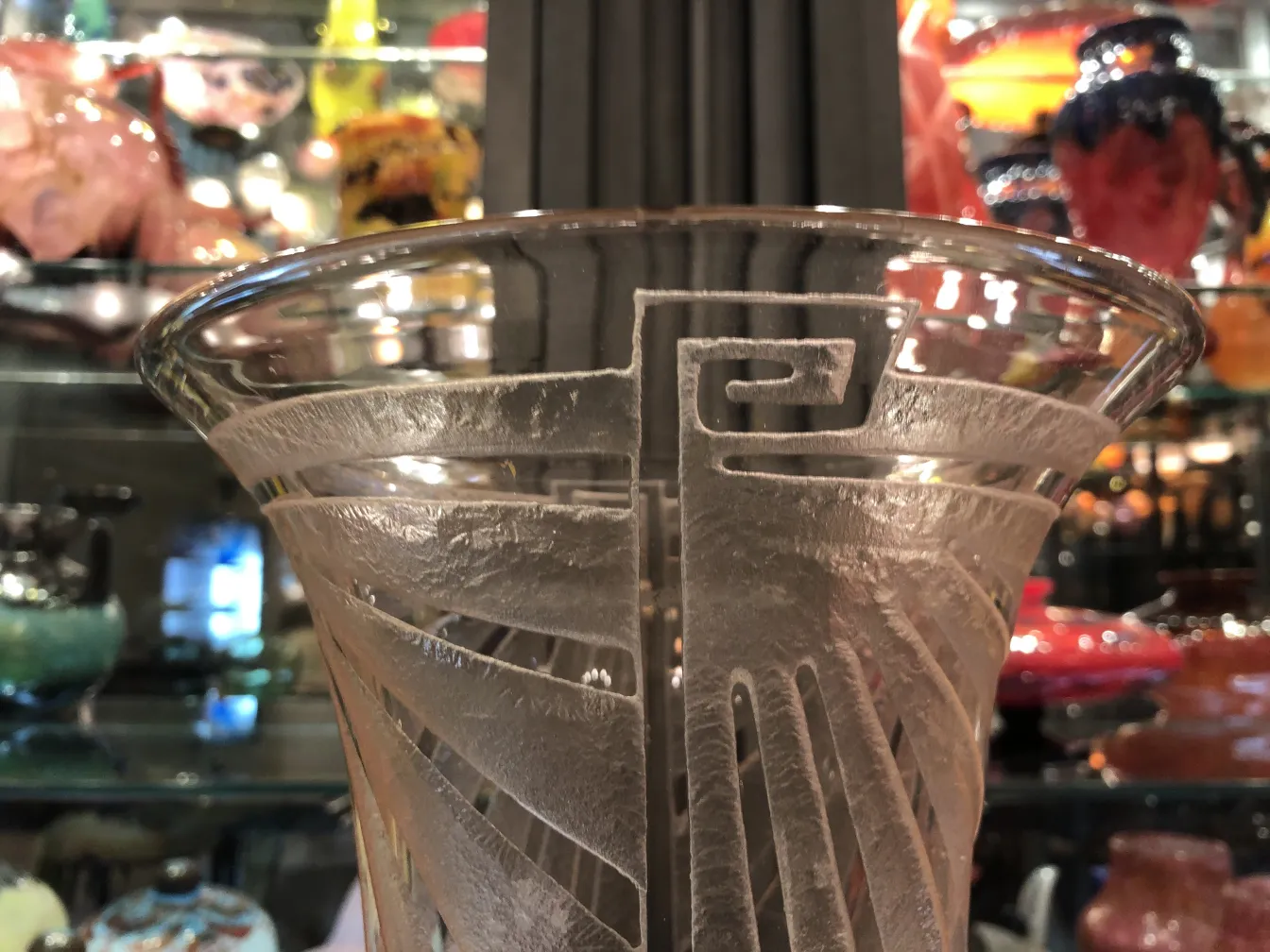 Antique glass with unique Schneider design in decorative setting.