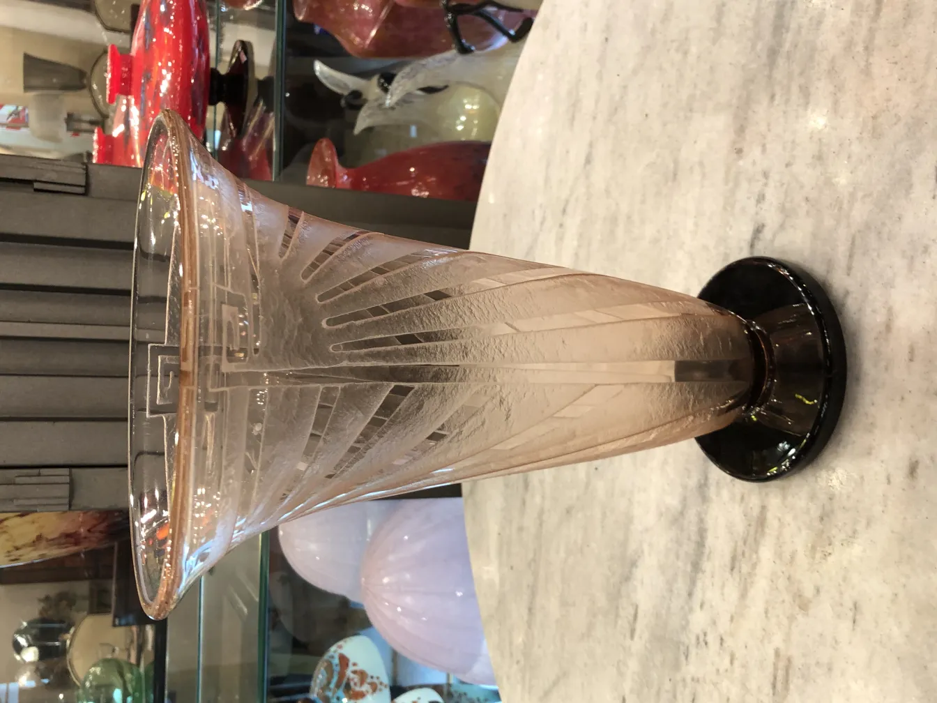 signed glass with geometric design, black base, antique