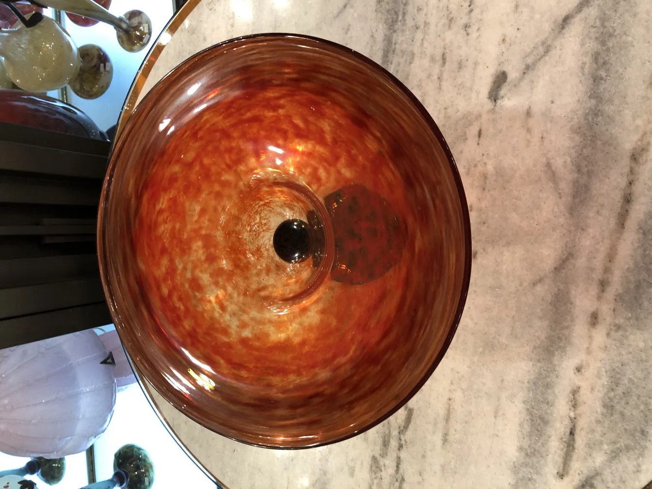 Antique signed glass with warm tones and dark base